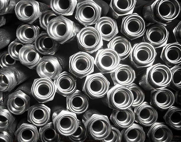 Metal hydraulic fittings stands on the silver table in the warehouse Metal hydraulic fittings stands on the silver table in the warehouse